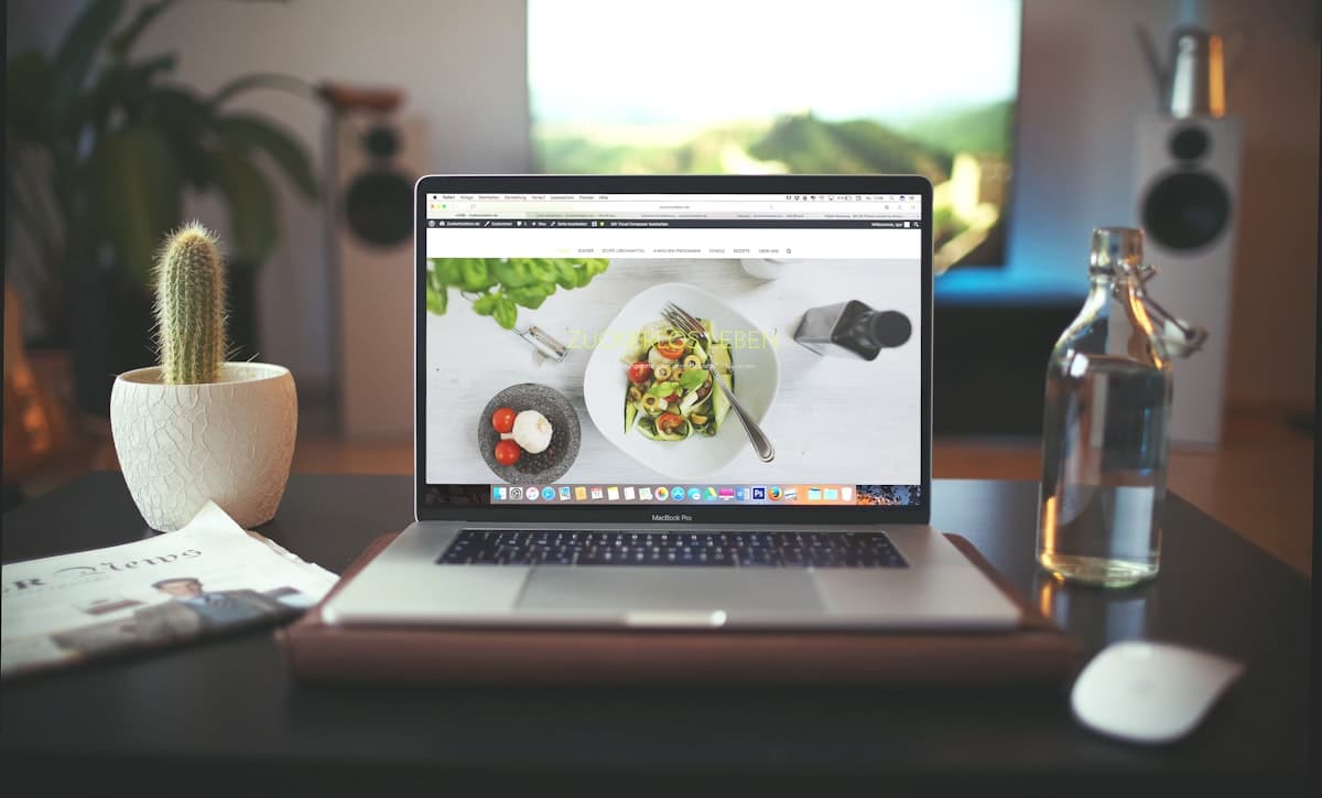 A website open on a laptop at a bright desk